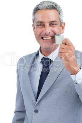 Cheerful man taking away adhesive tape from mouth