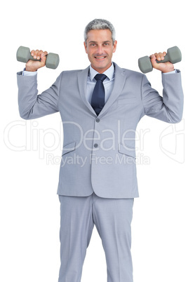 Businessman lifting dumbbells