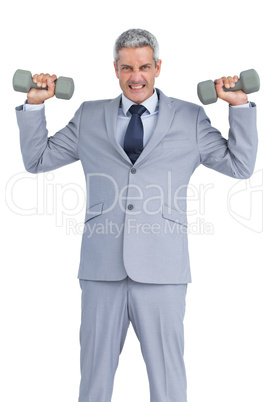 Strong businessman lifting dumbbells