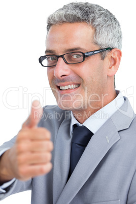 Handsome businessman wearing glasses and showing thumb up