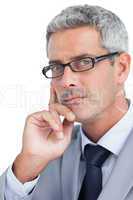 Thoughtful handsome businessman wearing glasses