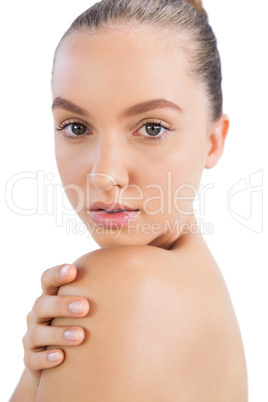 Model posing with hand on shoulder