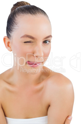 Model posing with tongue out and winking