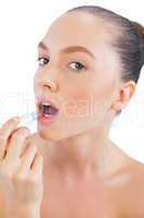 Model applying lip balm