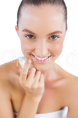 Happy model holding lip balm