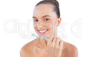Happy young model with toothbrush