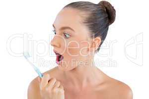 Young model looking at her toothbrush