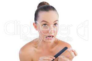 Nervous woman using nail file