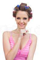 Happy young woman with hair curlers
