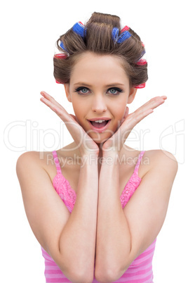 Cheerful young model with hair curlers