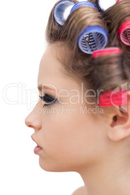 Profile of young model with hair curlers