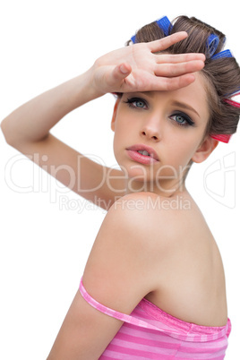 Beautiful model with hair curlers posing