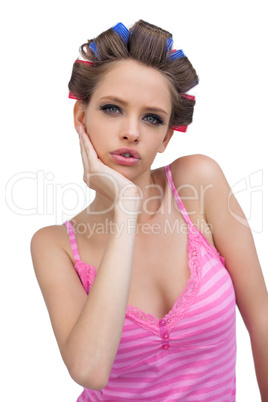 Cute young model posing wearing hair curlers