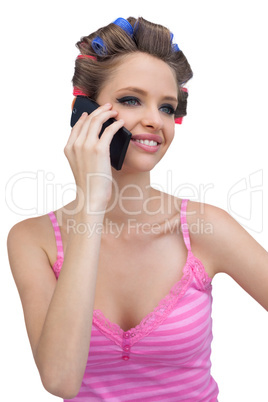 Smiling model with phone wearing hair rollers