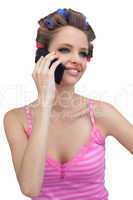 Smiling model with phone wearing hair rollers