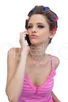 Kissing model wearing hair rollers with phone