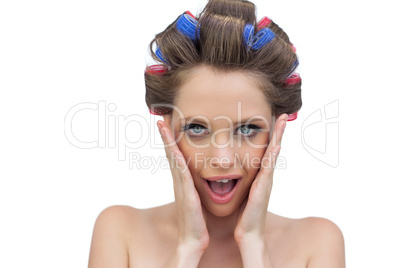 Astonished model in hair rollers posing