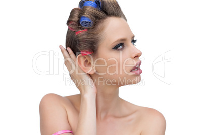 Pensive lady posing with hair curlers