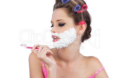 Young model posing and looking at razor
