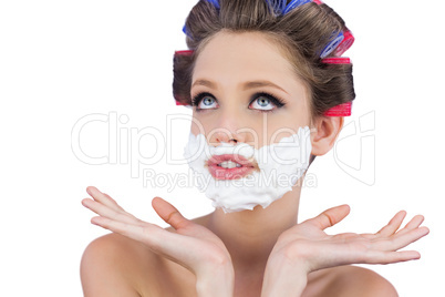 Pensive woman posing with shaving foam on face