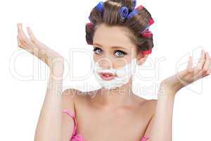 Questioning woman with shaving foam on face