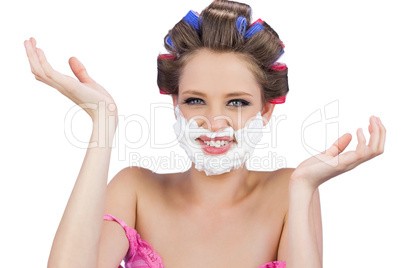 Cheerful woman with hands up and shaving foam on face