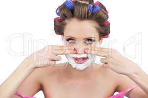 Young model with fingers on face and shaving foam