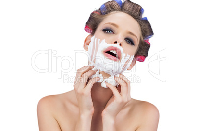 Sensual model with shaving foam looking at camera