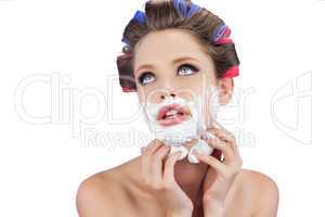 Thoughtful model touching her face with shaving foam