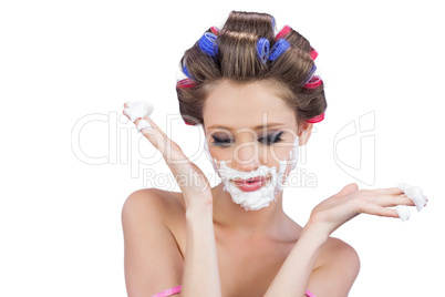 Interrogative woman posing with shaving foam