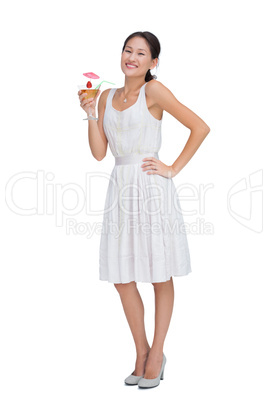 Cheerful brunette holding cocktail