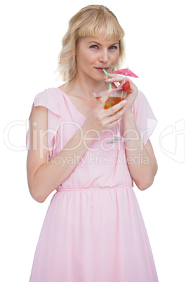 Pretty blond woman drinking cocktail