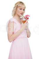 Pretty blond woman with cocktail and looking at camera