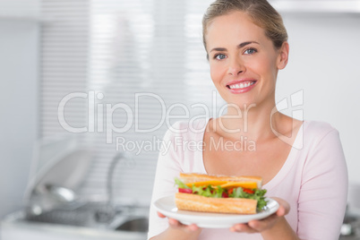 Happy woman holding sandwich