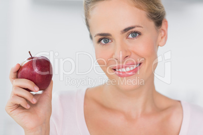 Woman holding apple in right hand