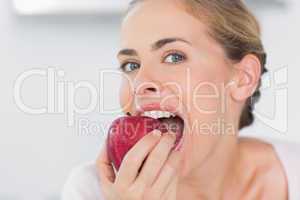 Attractive woman munching apple