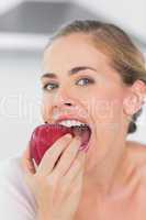 Attractive woman munching red apple