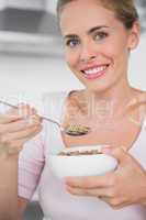 Smiling woman holding bowl of cereal