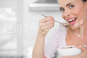 Pretty woman holding bowl of cereal