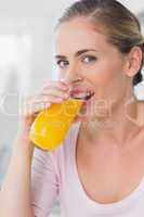 Pretty woman drinking orange juice