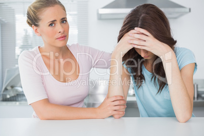 Understanding woman comforting her upset friend