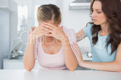 Woman looking at her overwhelmed friend
