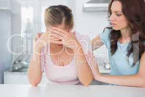 Woman looking at her overwhelmed friend