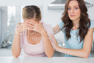 Woman comforting her overwhelmed friend