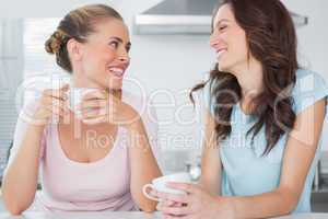 Laughing friends having cup of coffee