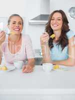 Happy women eating cake and having coffee together