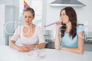 Woman cheering up her upset friend on her 30th birthday