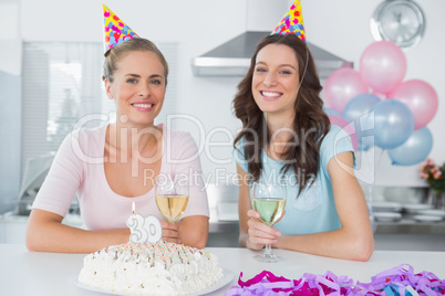 Cheerful women drinking white wine and celebrating birthday