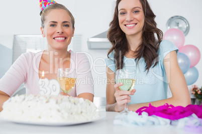 Cheerful women with birthday cake