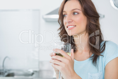 Radiant brunette drinking white wine